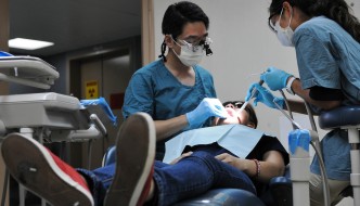 A dentist performs a root canal.